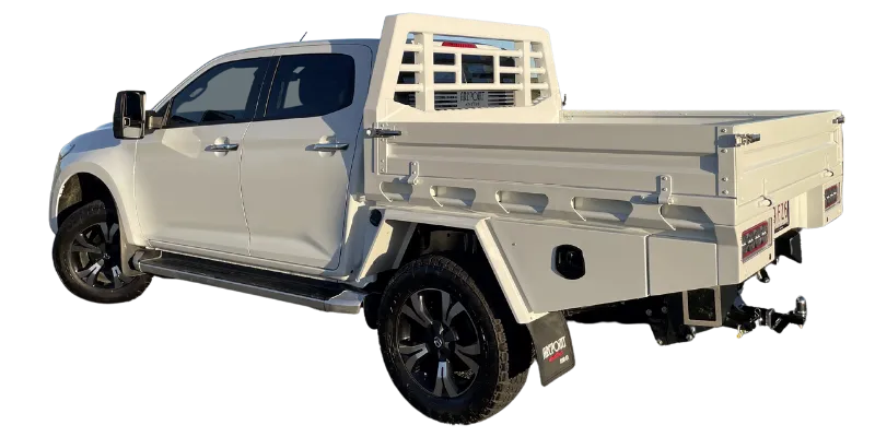 A white pickup truck with a custom cream-colored metal utility bed and rear rack guard, shown from a three-quarter rear angle against a plain white background.