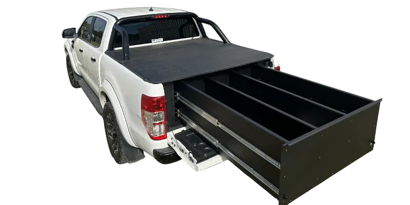 A white pickup truck with a black tonneau cover and an extended black under-bed storage drawer, shown on a plain white background.