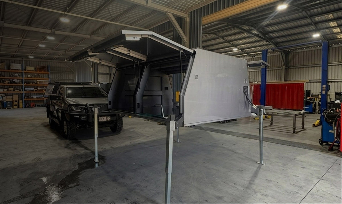 ArcPoint Lift-Off Package canopy separated from the ute in a workshop, demonstrating the removable canopy system